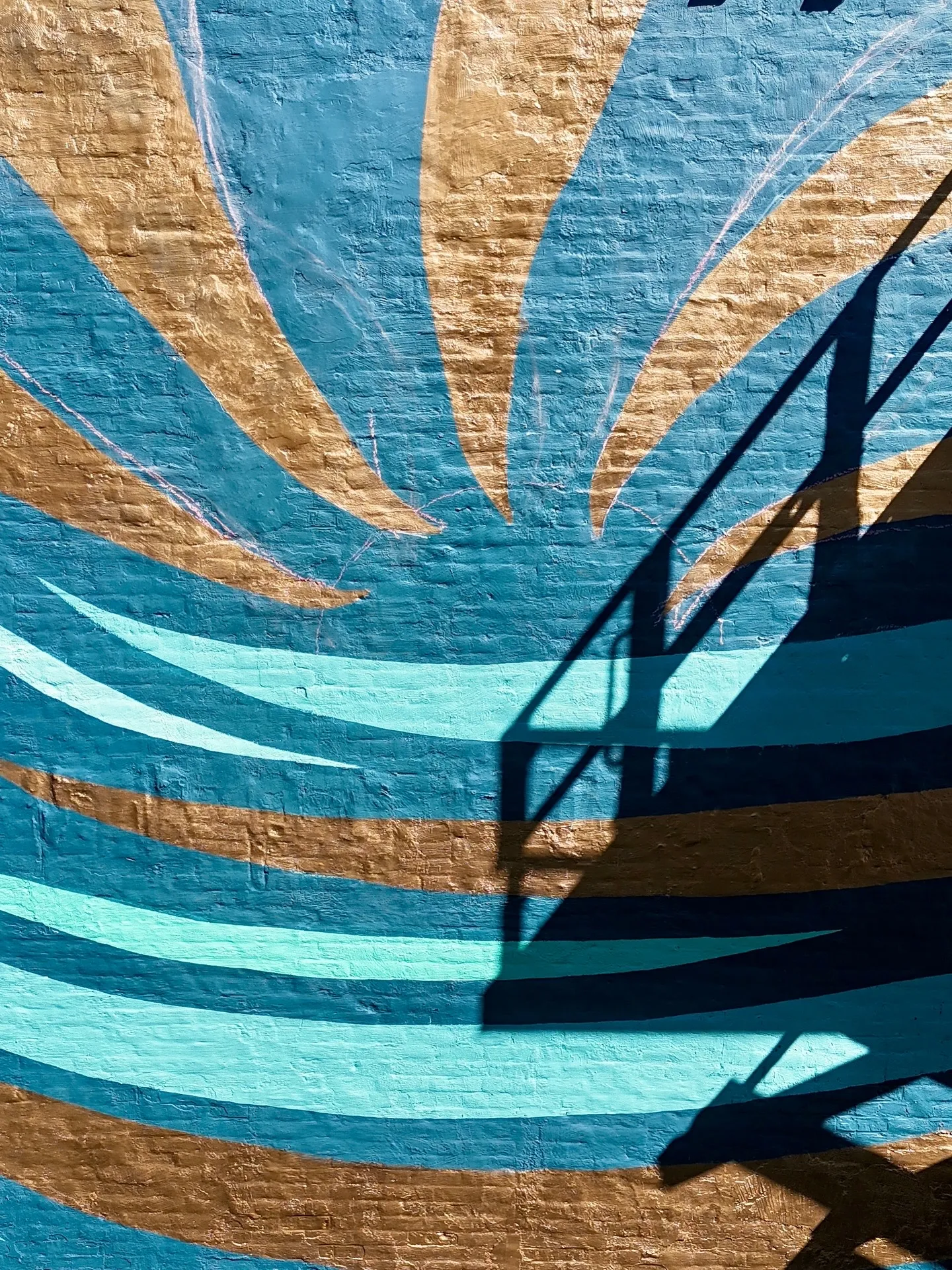 Currents mural detail on the exterior brick wall.