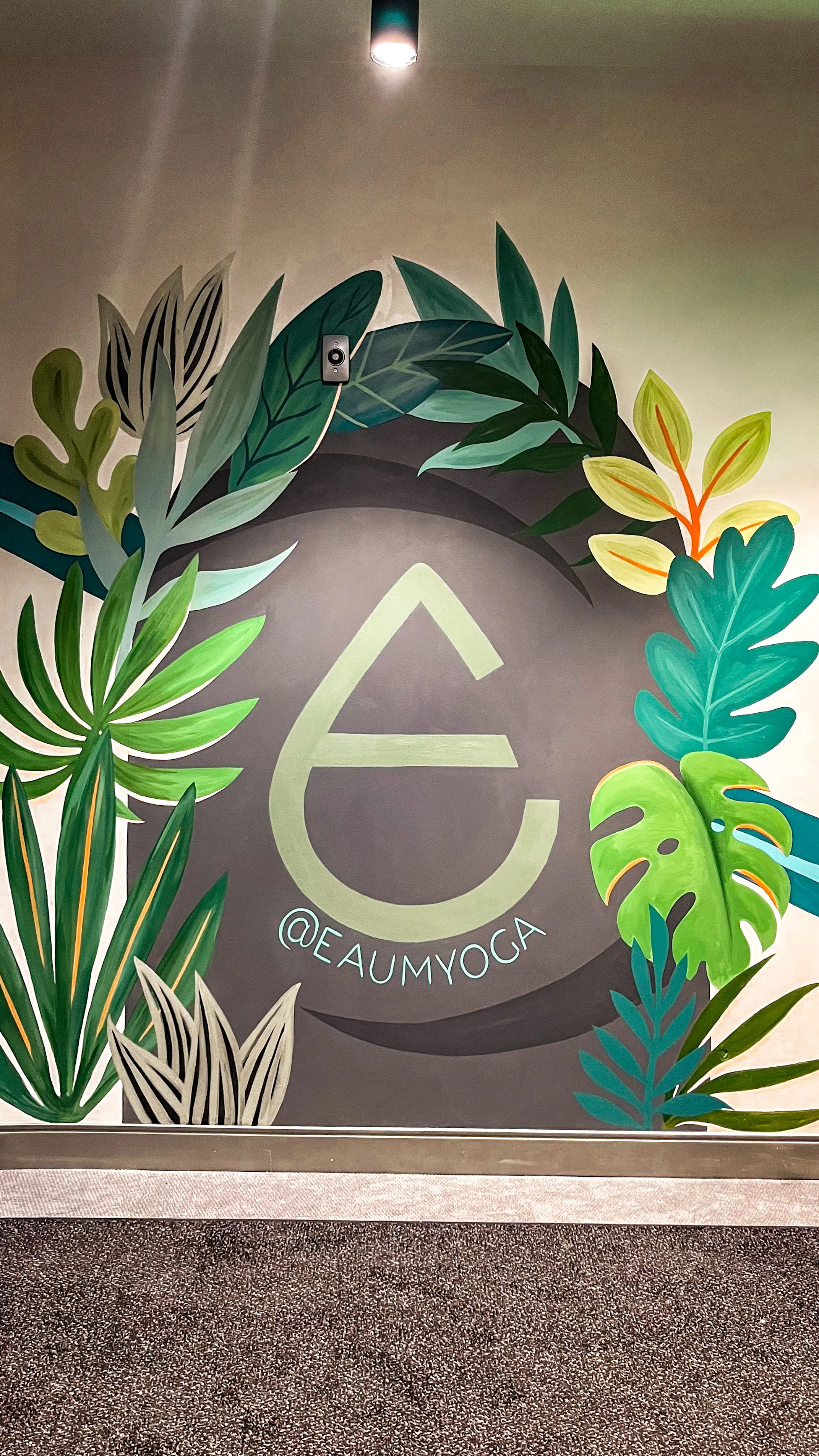 Interior yoga studio mural with saturated color and metallic accents.