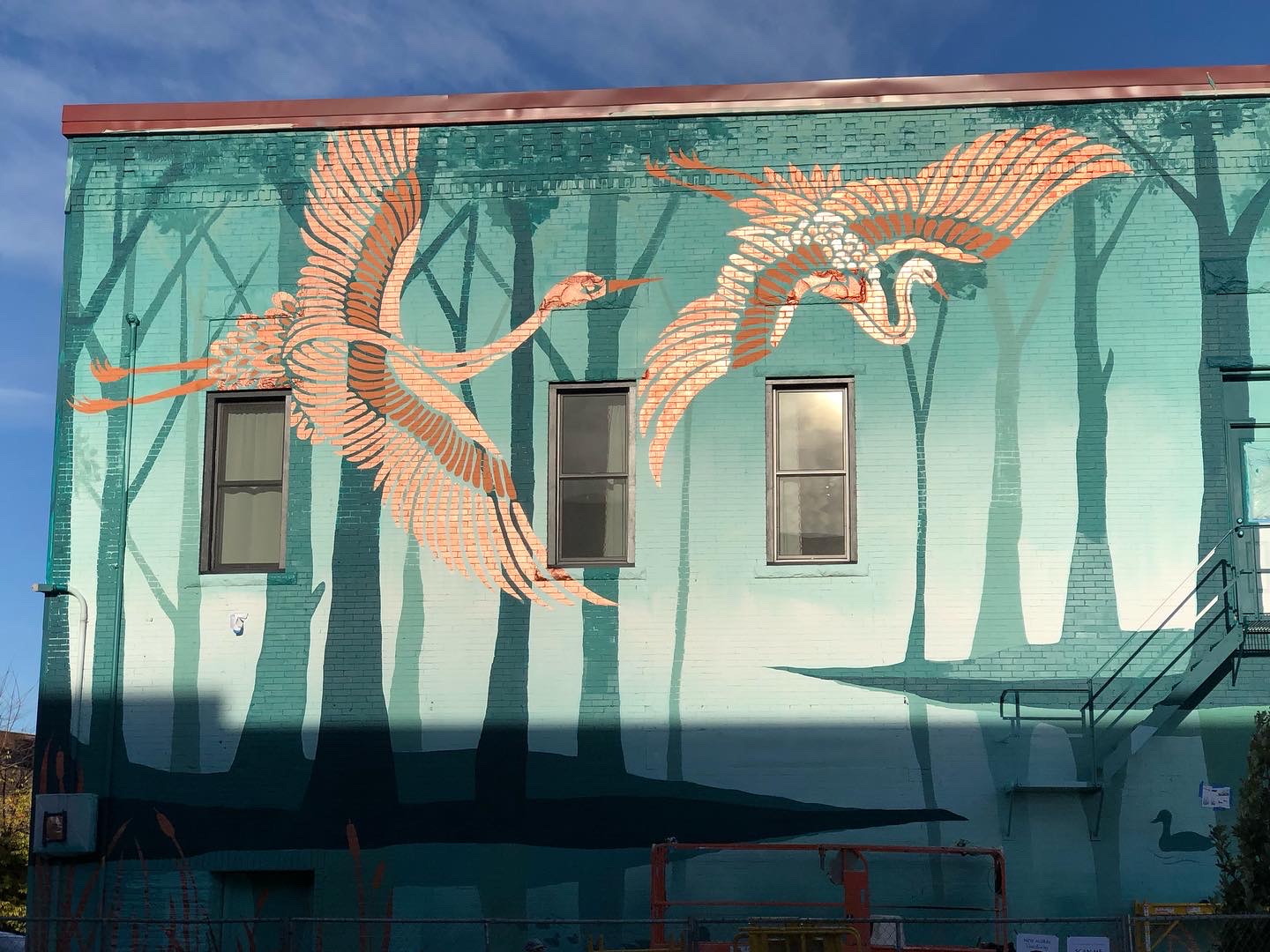 Wider view of the Sanctuary mural on the downtown wall.