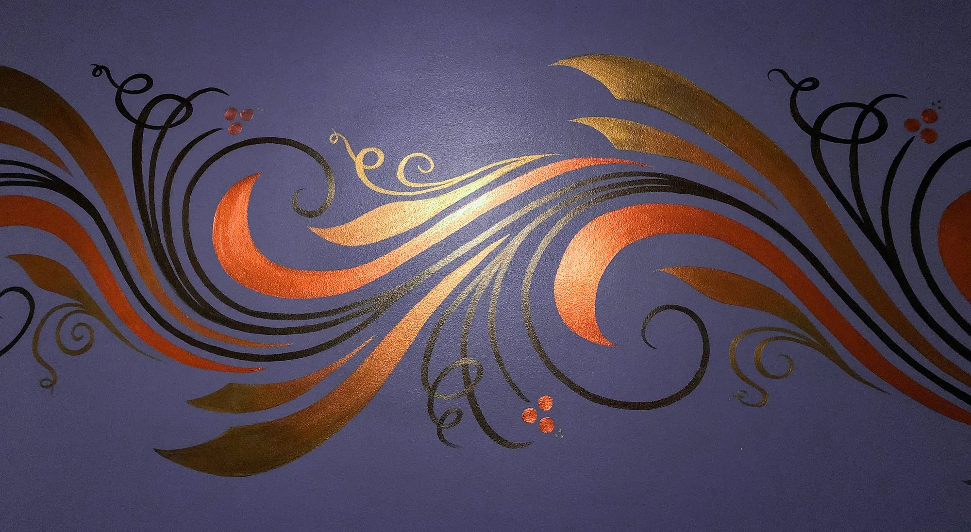 Copper, gold, and black feather-scroll mural sweeping across a deep purple wall.