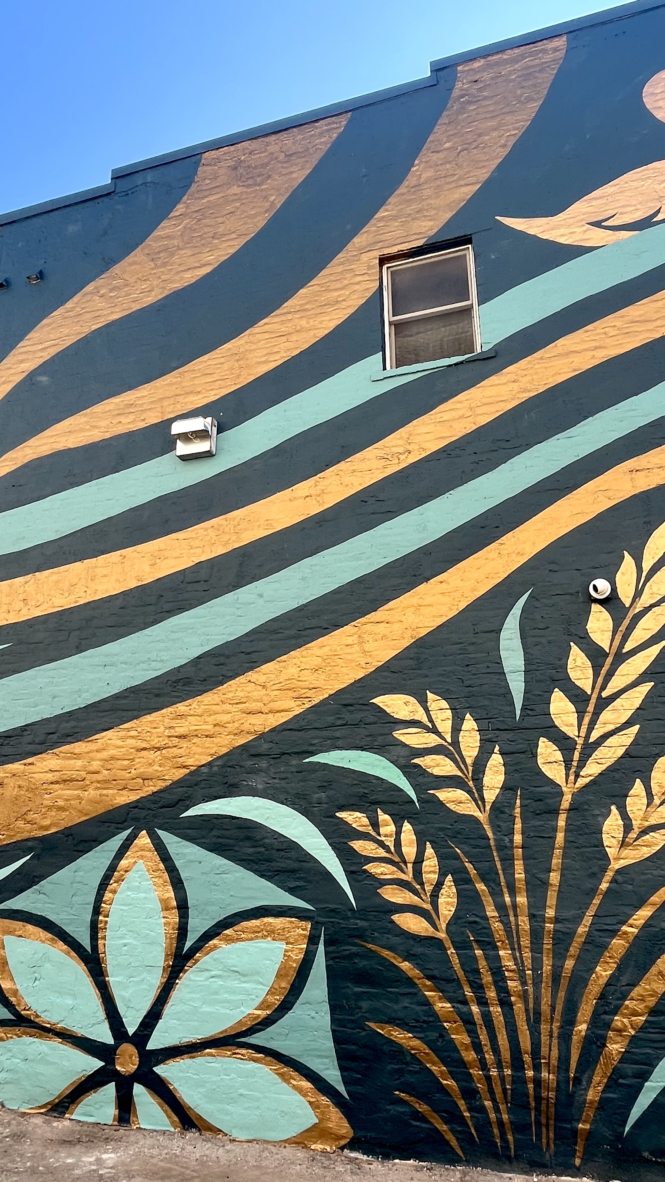 Currents mural showing layered waves and fish.