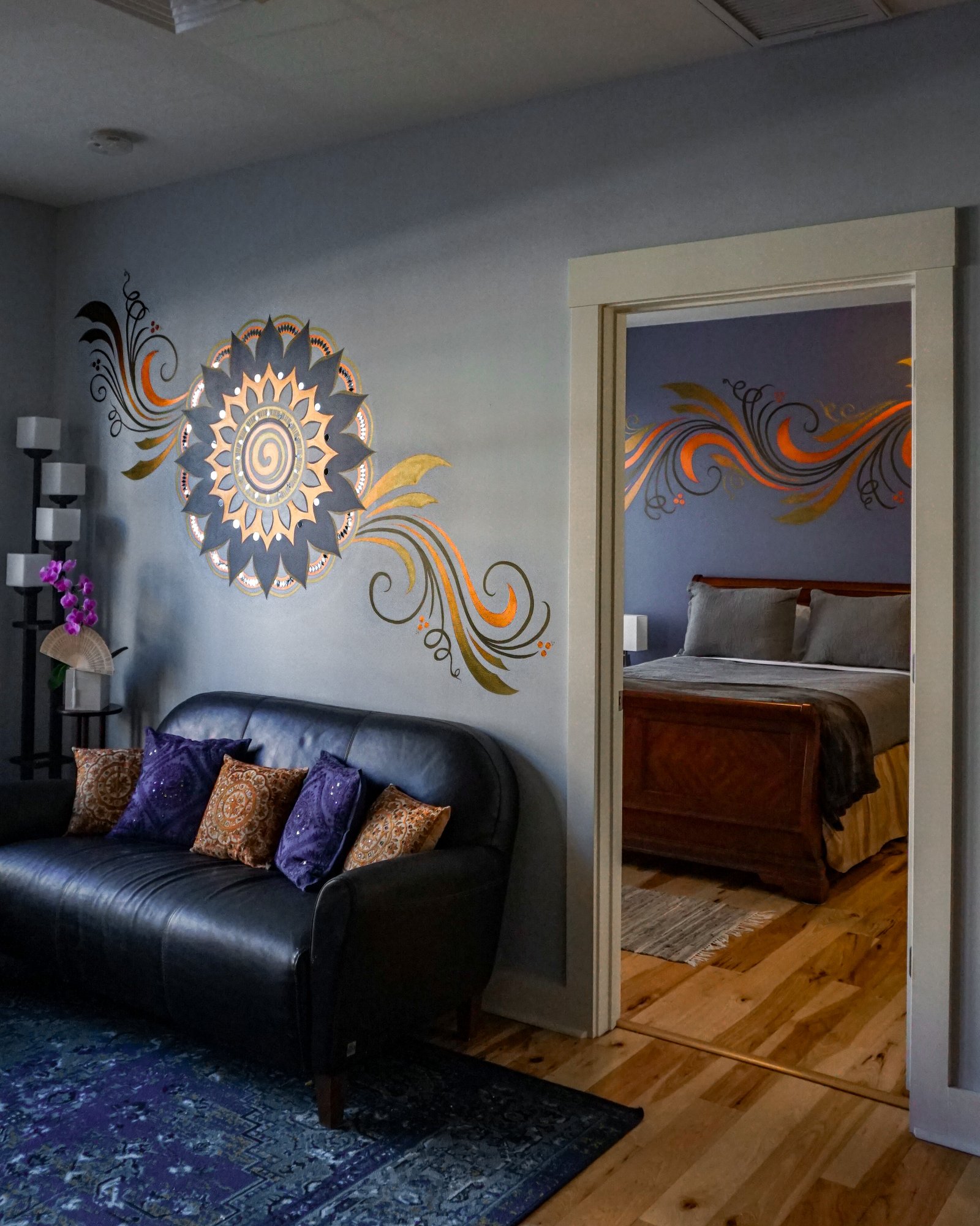 Sunburst medallion mural with a view through to the bedroom scrollwork beyond.