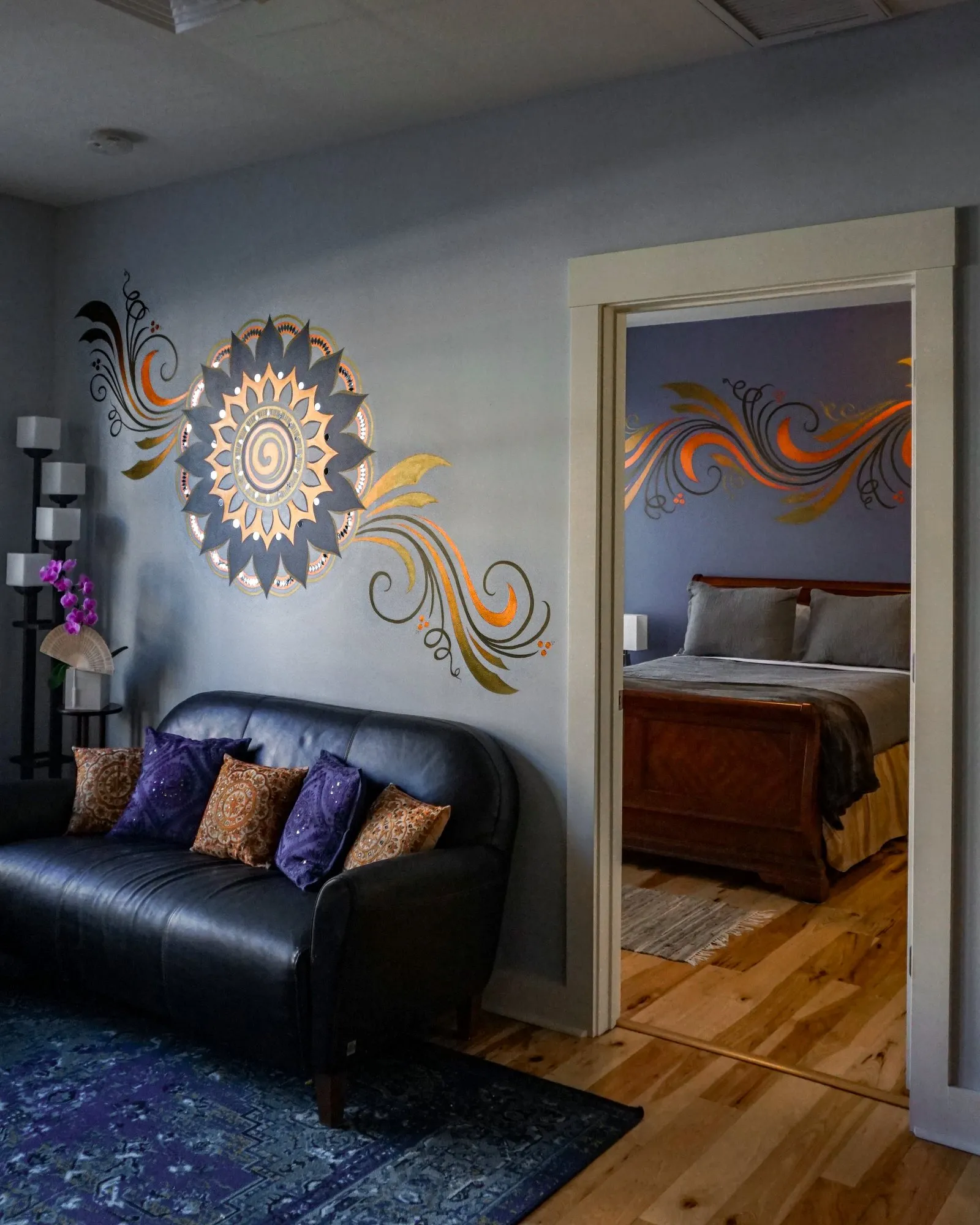 Sunburst medallion mural with a view through to the bedroom scrollwork beyond.