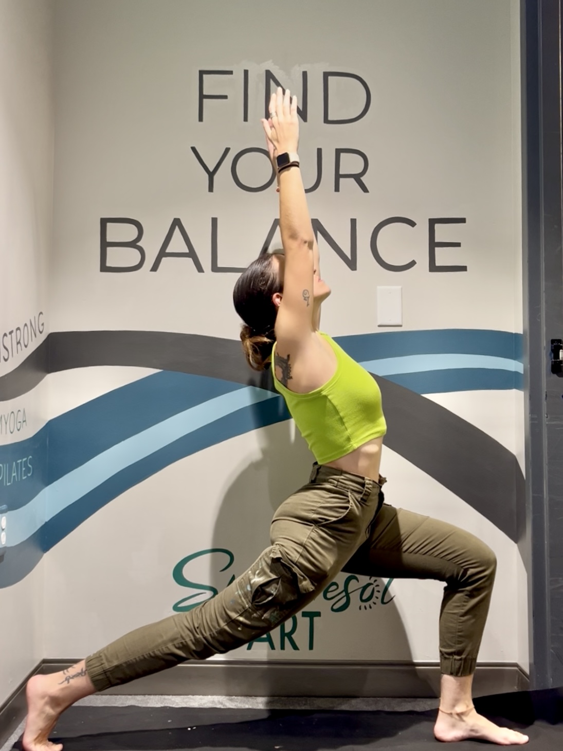 Eaum Yoga studio in use with the mural backdrop.