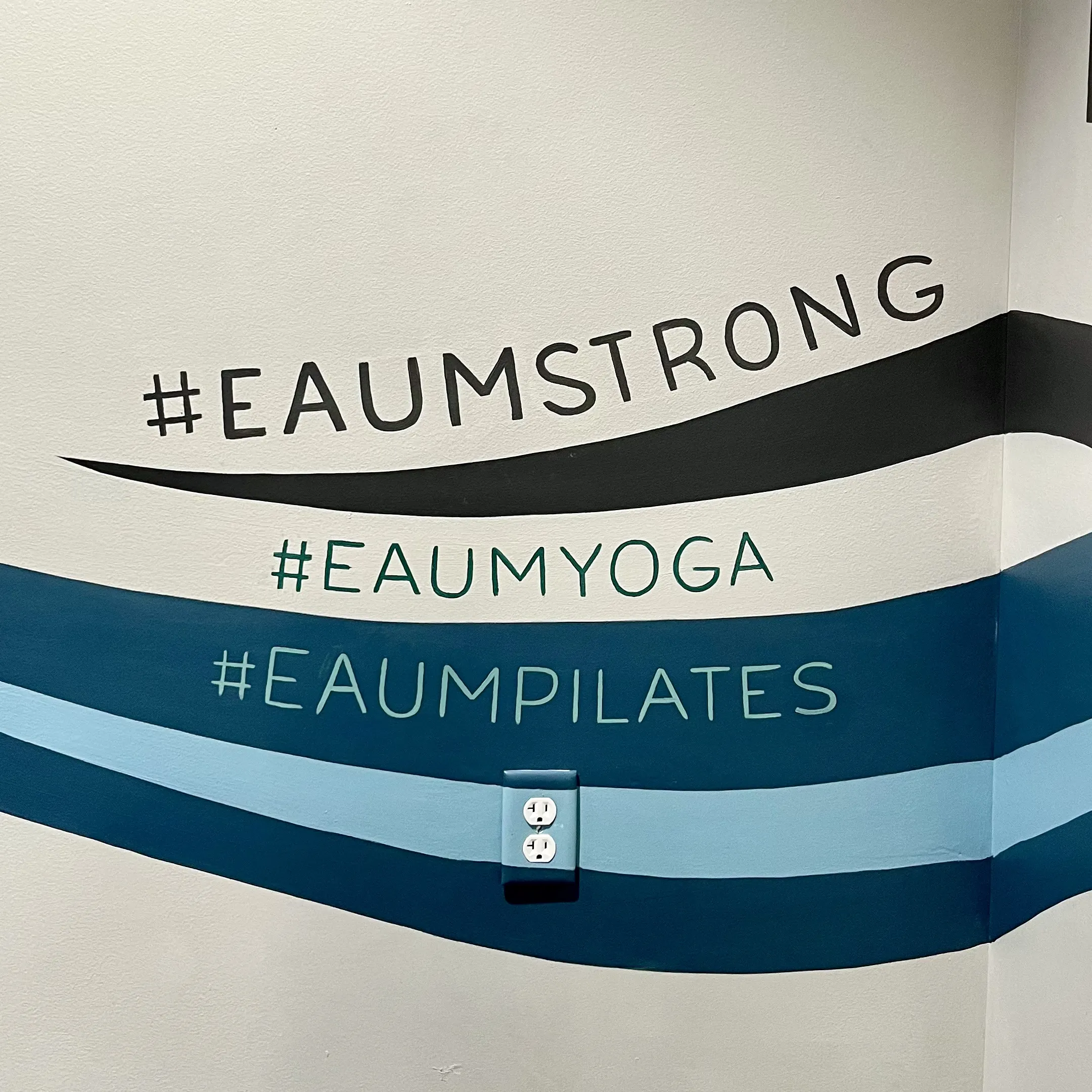 Eaum Yoga interior with mural section visible.
