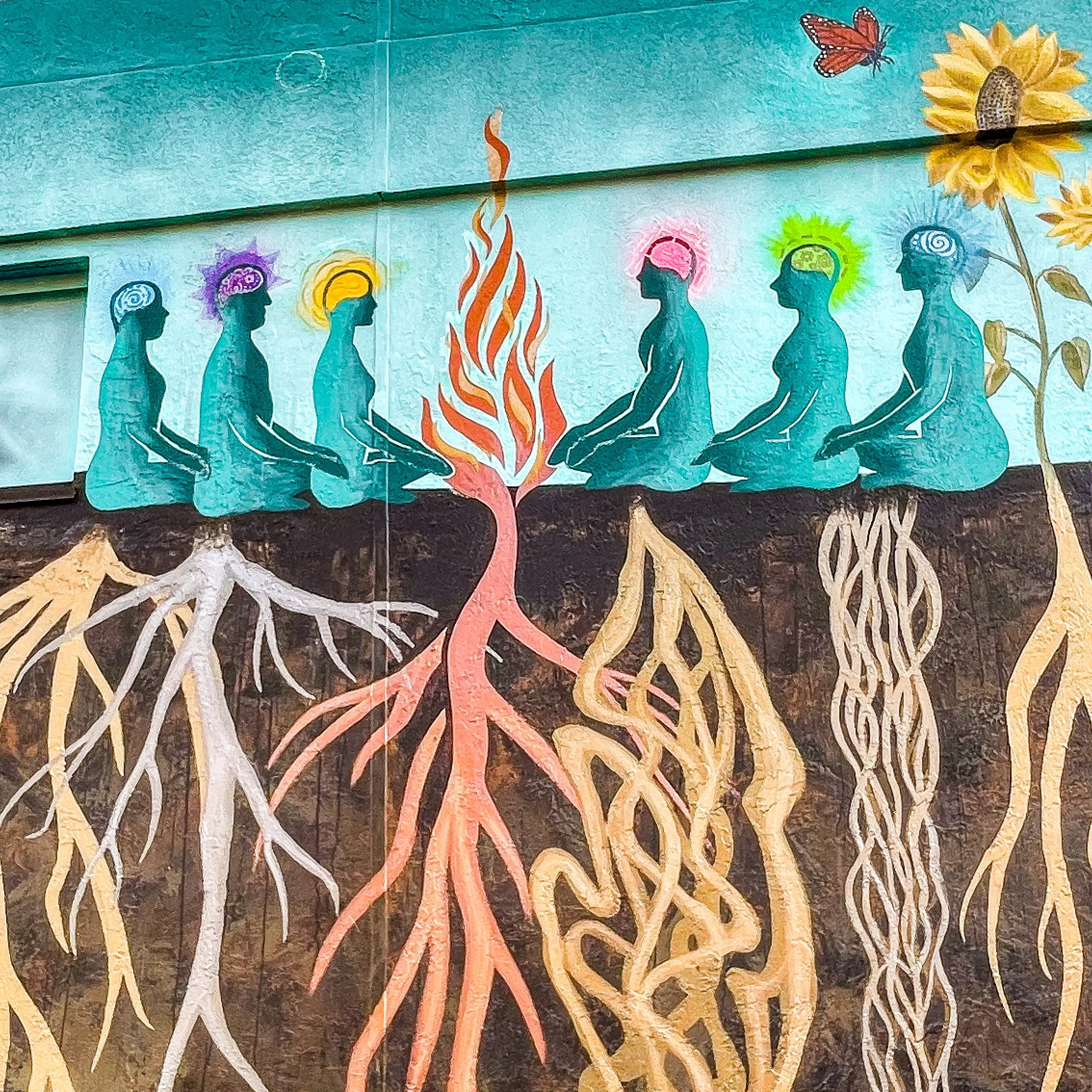 Roots mural detail showing root systems and figures.